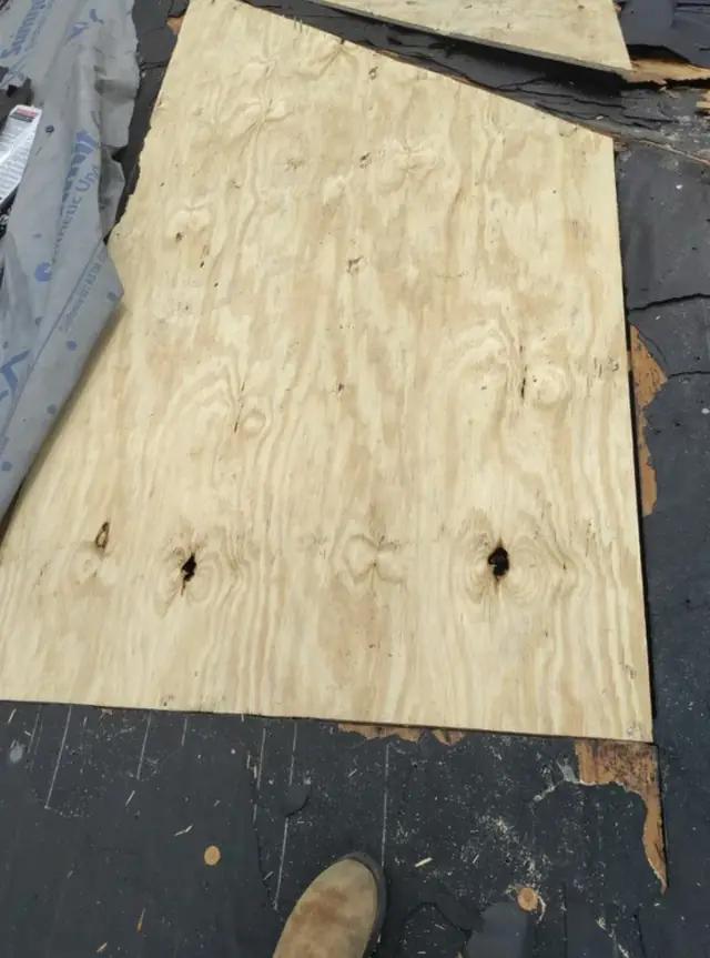 New plywood roof decking and synthetic underlayment laid during a tear-off